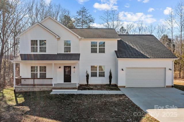 view of front of property with covered porch and a garage