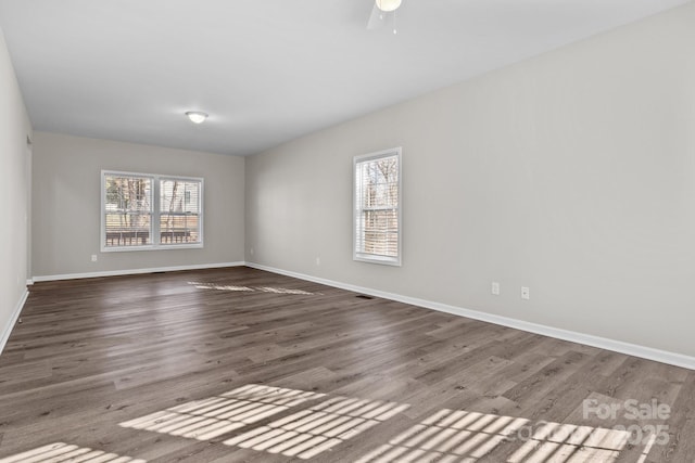 empty room featuring ceiling fan and dark hardwood / wood-style floors