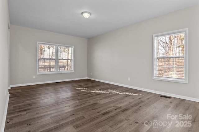 unfurnished room featuring dark hardwood / wood-style floors