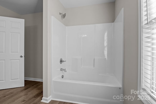 bathroom featuring shower / bathing tub combination and hardwood / wood-style floors