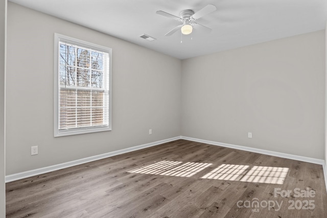 empty room featuring ceiling fan and hardwood / wood-style flooring