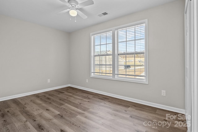 empty room with ceiling fan and wood-type flooring