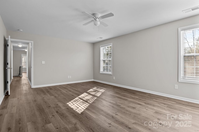 spare room with ceiling fan and dark hardwood / wood-style flooring