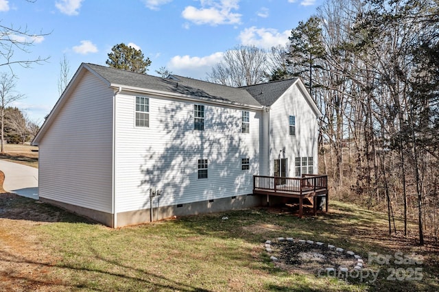 view of home's exterior with a deck and a yard