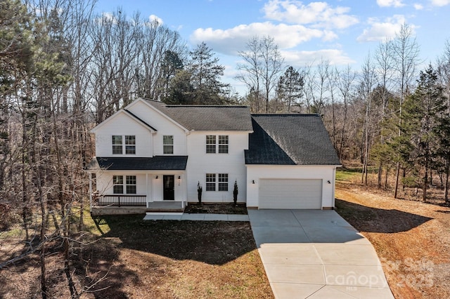 view of property with a garage and covered porch