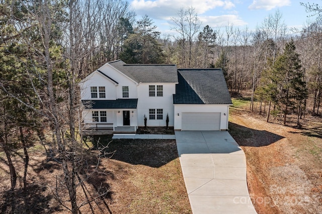 view of property featuring a garage and a porch