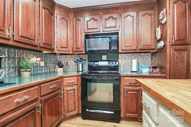 kitchen with backsplash, black appliances, and wooden counters