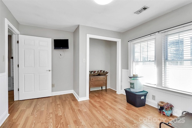 interior space featuring light hardwood / wood-style floors and multiple windows