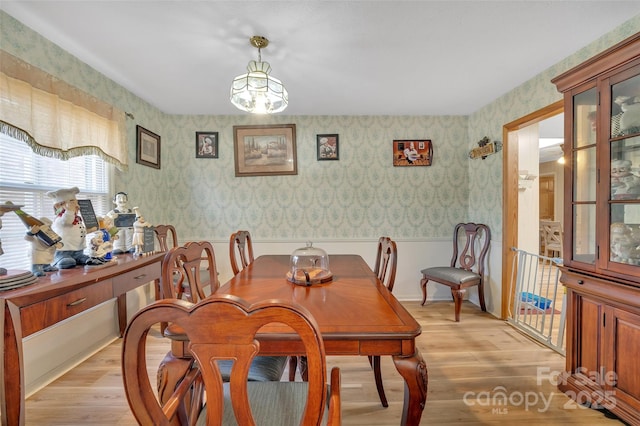 dining room featuring light hardwood / wood-style flooring and an inviting chandelier