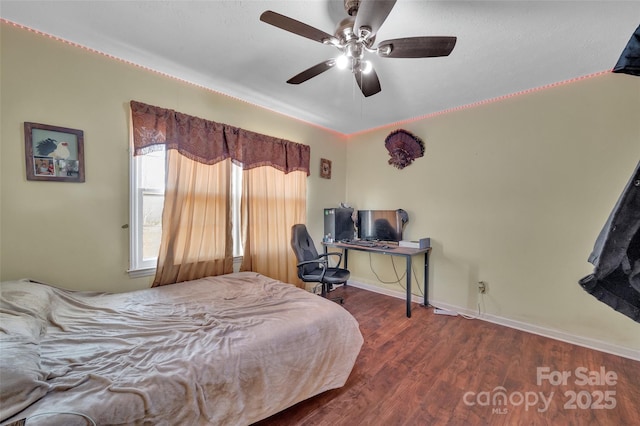 bedroom featuring ceiling fan and dark hardwood / wood-style floors