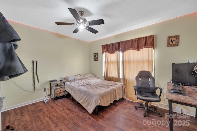 bedroom featuring ceiling fan and dark hardwood / wood-style floors