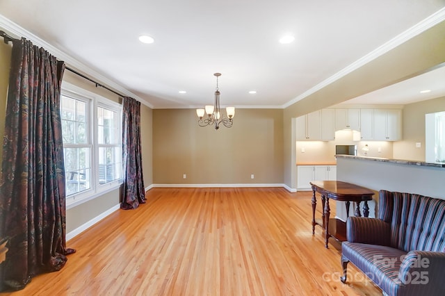 interior space with crown molding, light hardwood / wood-style floors, and a chandelier