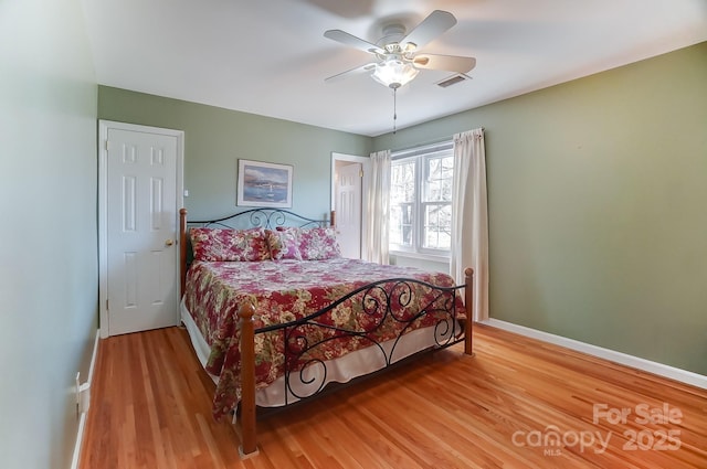 bedroom with hardwood / wood-style floors and ceiling fan