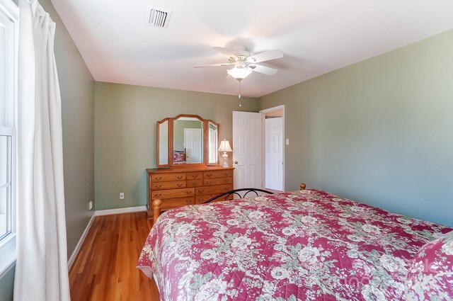 bedroom with hardwood / wood-style flooring and ceiling fan