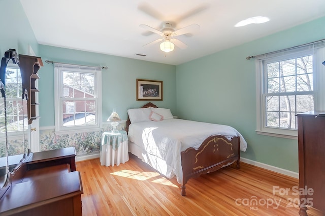 bedroom with ceiling fan and light hardwood / wood-style flooring