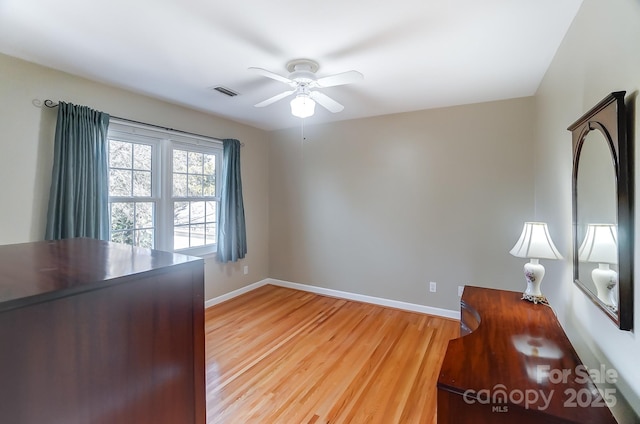 unfurnished office featuring light hardwood / wood-style flooring and ceiling fan