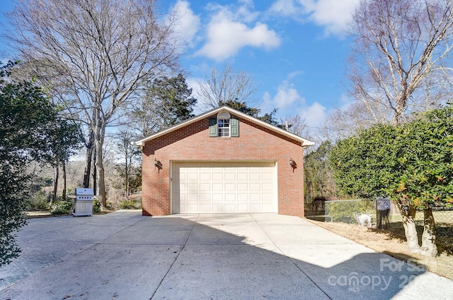 view of side of property featuring a garage and an outbuilding