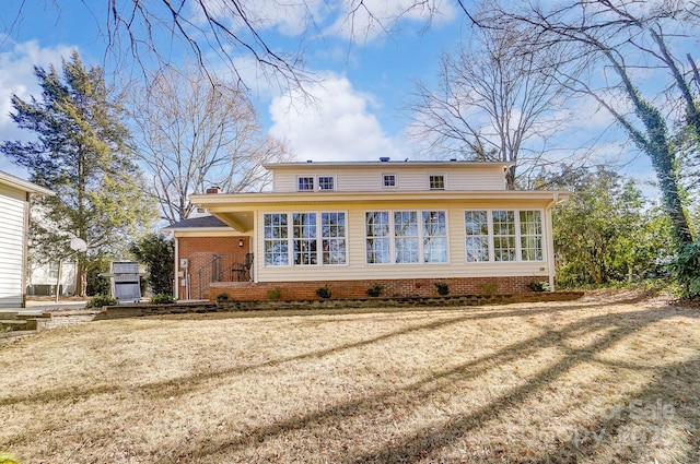 back of house with a lawn