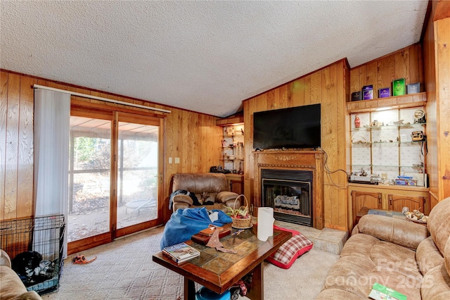 living room featuring light colored carpet, a textured ceiling, and wooden walls