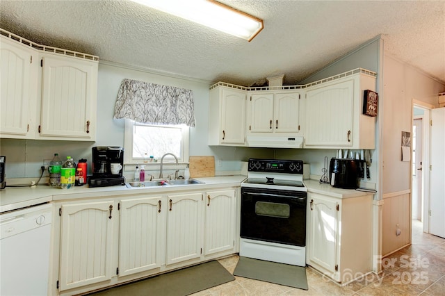 kitchen featuring white appliances, sink, a textured ceiling, light tile patterned flooring, and white cabinetry