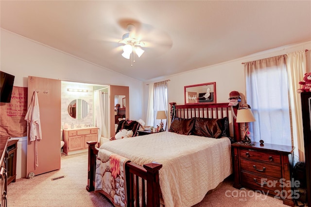 bedroom with light carpet, ensuite bath, ceiling fan, and lofted ceiling