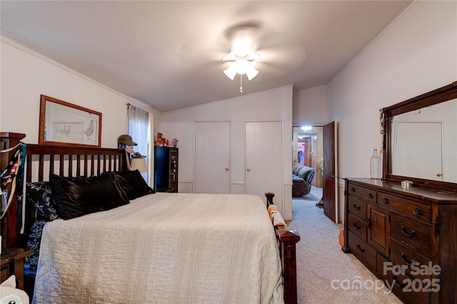 carpeted bedroom with vaulted ceiling and ceiling fan