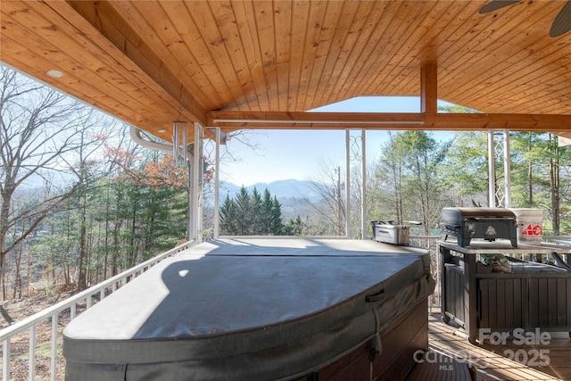 view of patio / terrace featuring a mountain view, a hot tub, and area for grilling