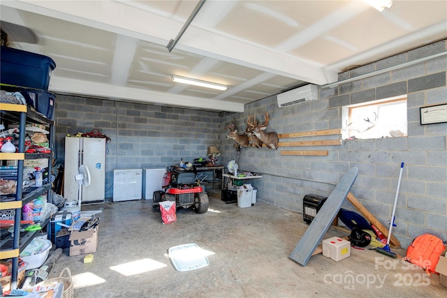 garage featuring a wall unit AC, fridge, and white refrigerator