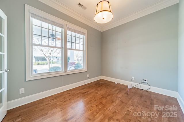 unfurnished room featuring wood-type flooring and crown molding