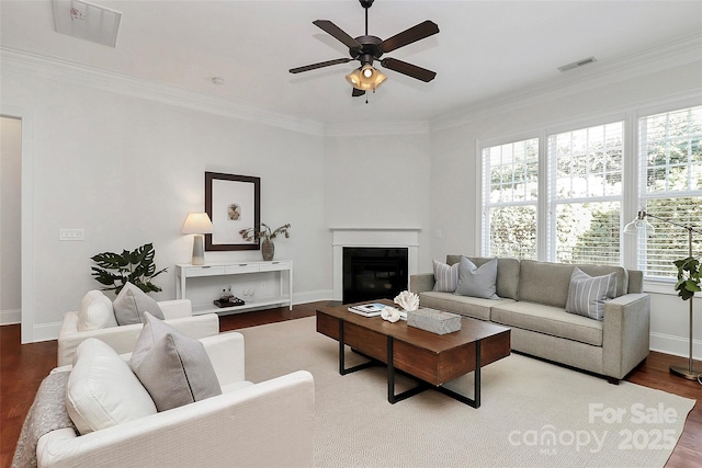 living room featuring ceiling fan, wood-type flooring, and crown molding