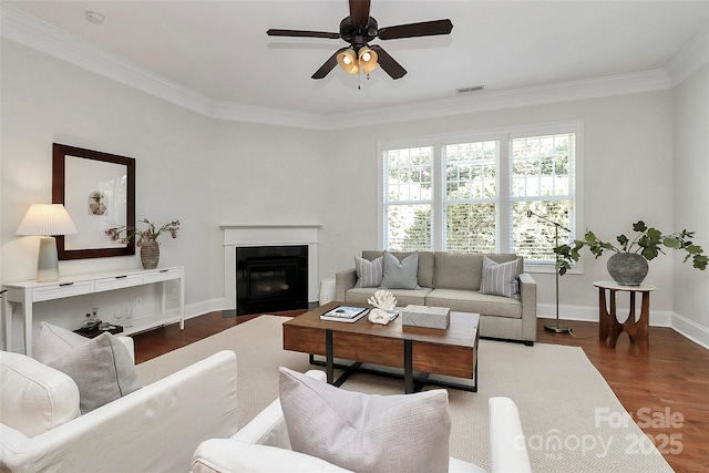 living room with ceiling fan, dark hardwood / wood-style flooring, and crown molding