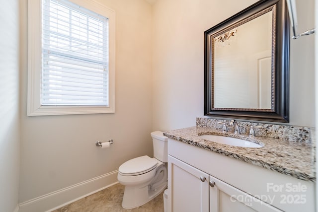 bathroom with toilet, tile patterned floors, and vanity