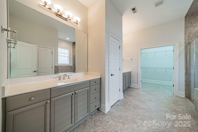 bathroom featuring walk in shower and vanity