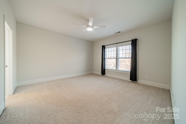 carpeted spare room with ceiling fan