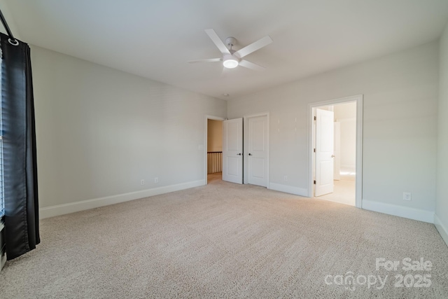 unfurnished bedroom with connected bathroom, ceiling fan, and light colored carpet