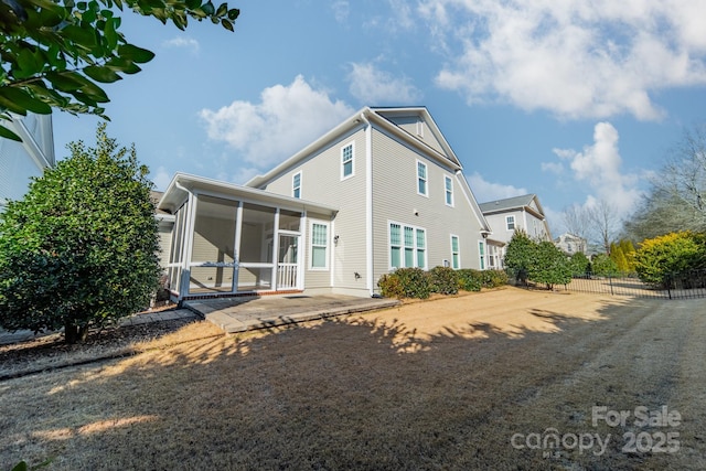 back of house featuring a sunroom