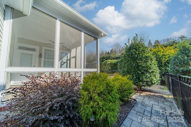 exterior space featuring ceiling fan and a sunroom