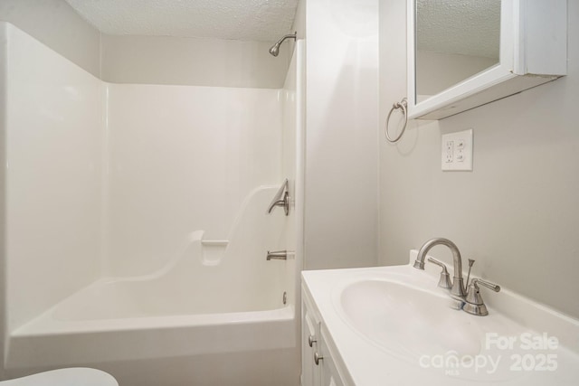 full bathroom with toilet, a textured ceiling, bathing tub / shower combination, and vanity