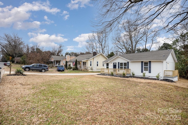 view of front of property featuring covered porch and a front yard