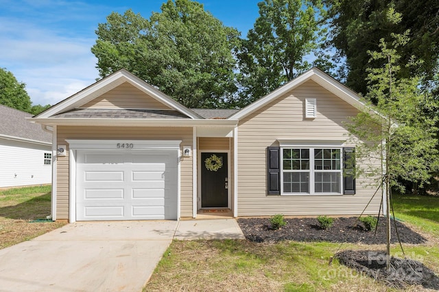 ranch-style home with a garage and a front yard