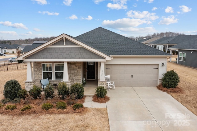 craftsman inspired home featuring a porch and a garage