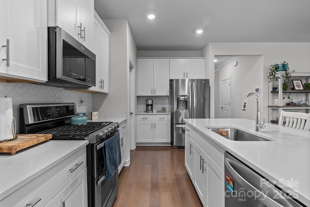 kitchen featuring white cabinetry, appliances with stainless steel finishes, sink, and decorative backsplash