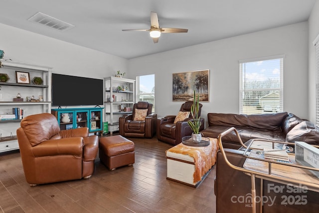 living room featuring ceiling fan and dark hardwood / wood-style flooring