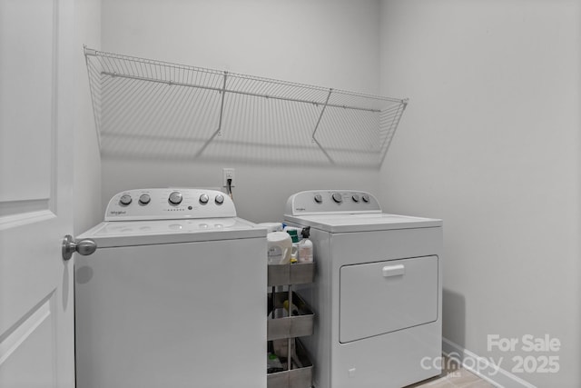 clothes washing area featuring separate washer and dryer