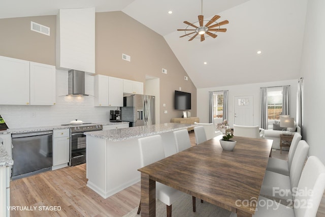 interior space featuring vaulted ceiling, ceiling fan, and light hardwood / wood-style floors