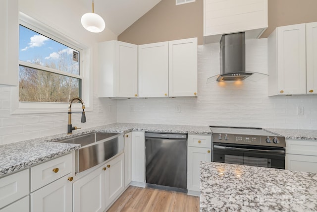 kitchen with decorative light fixtures, black dishwasher, white cabinets, electric range, and wall chimney exhaust hood