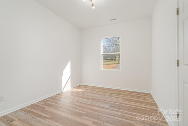 spare room with light hardwood / wood-style flooring