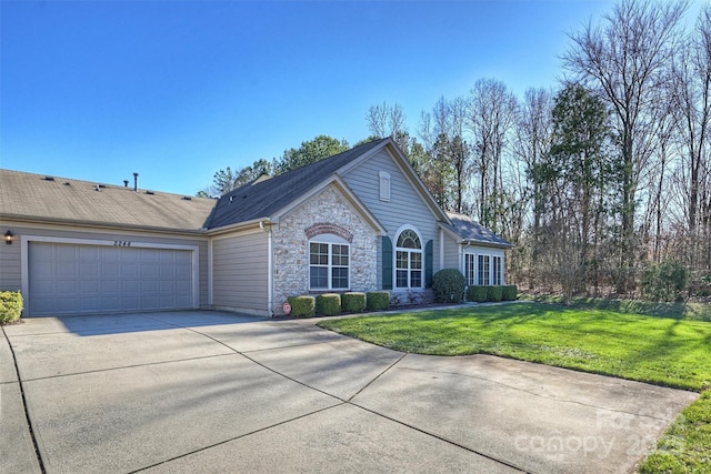 ranch-style home with a front lawn and a garage