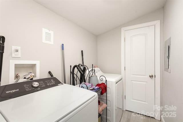 washroom with electric panel and independent washer and dryer