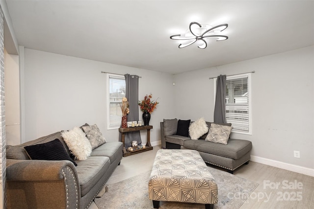 living room featuring light hardwood / wood-style floors and a notable chandelier